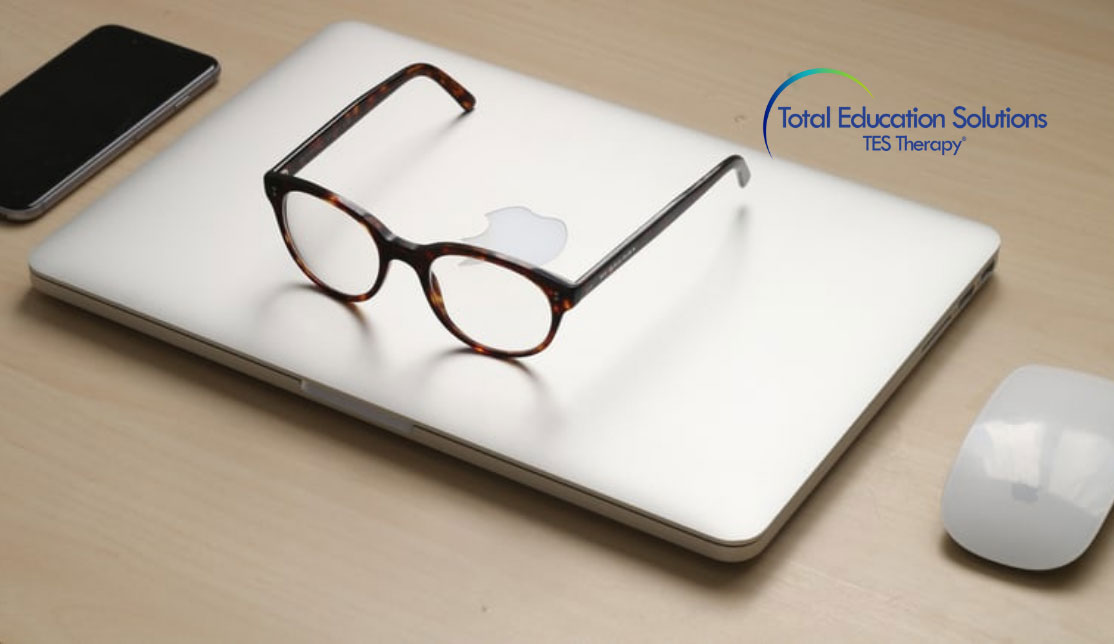 Screen time and eye health blog banner image. Glasses on laptop